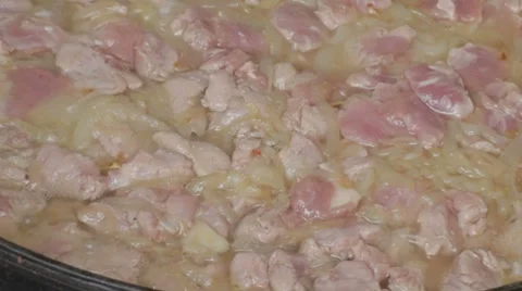 Cut pork with sliced onions keeps languishing, close-up Stock-Footage 7752945