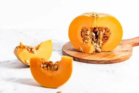 Cut pumpkin on the kitchen table Stock Photos