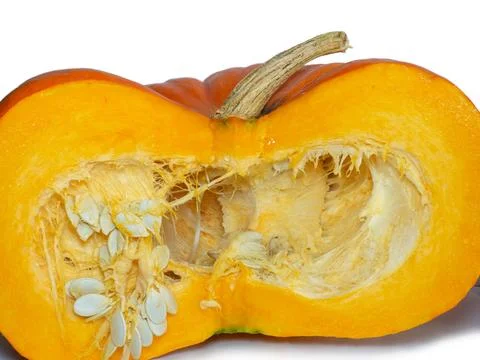 Cut pumpkin on a white background. Pumpkin isolate. Vegetable cut in half. Stock Photos