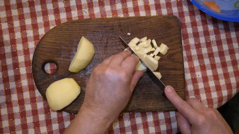 Cut Raw Potatoes on Board with Knife. Cooking Salad at Home. Preparing Homemade. 動画素材 127774853