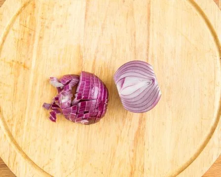 Cut the red onion into small cubes. Top view of purple bow Stock Photos