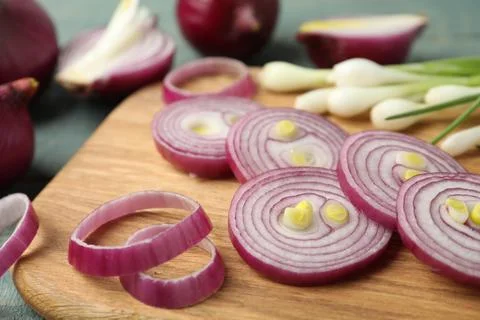 Cut red onion on wooden board, closeup Stock Photos