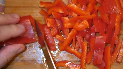 Cut Red Pepper on Board with Knife. Cooking Salad at Home. Homemade. Top view. Stock Footage 127786125