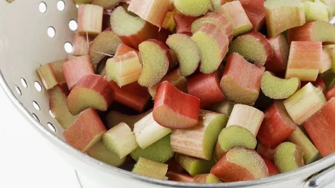 Cut rhubarb pieces in a colander Stock Footage 76323906