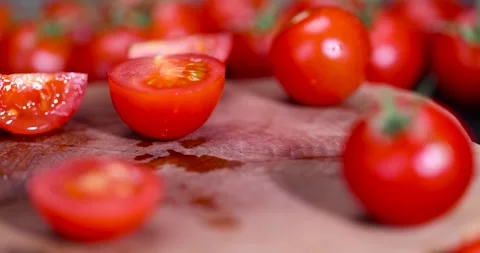 Cut ripe small red tomatoes during cooking, several red round cherry tomatoes on Stock Footage 311351196