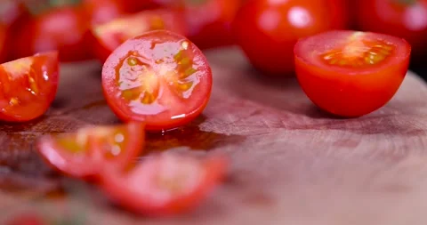 Cut ripe small red tomatoes during cooking, several red round cherry tomatoes on Stock Footage 311793658