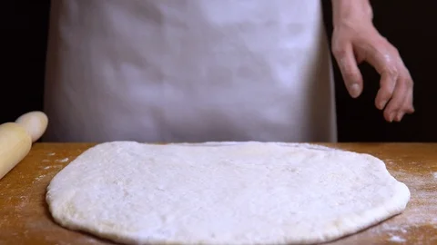 Cut the rolled out dough manually into pieces. close-up 4K Stock Footage 111769828