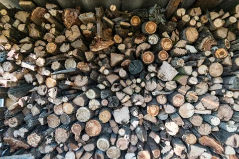 Cut round logs - firewood stack background pattern Stock Photos