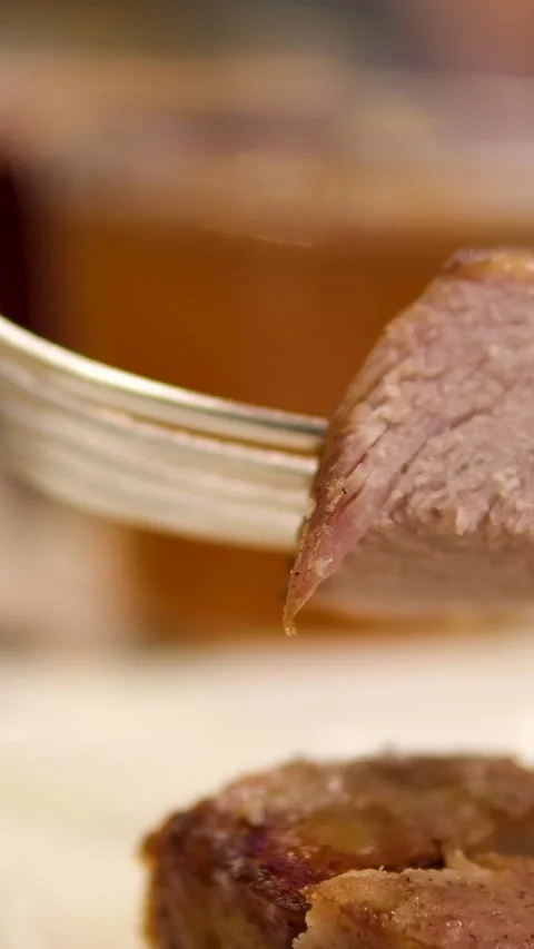Cut the shashlik with a fork and knife fried meat in a plate vertical video Stock Footage 292008188