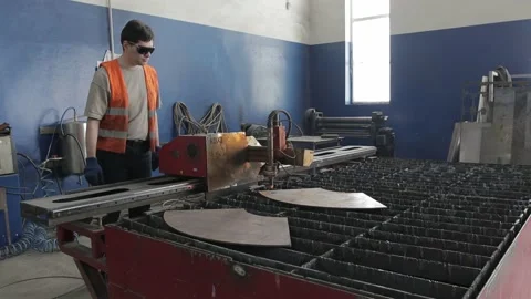 Cut sheet metal at workshop. Modern tool in heavy industry. Dangerous job. High Stock Footage 142901554
