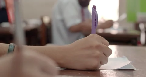 Cut-in shot while the students are writing the answers on their paper. Stock Footage 255716339
