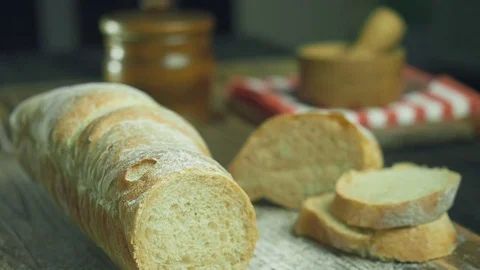 Cut slice of bread in slow motion, close up Stock Footage 72789063