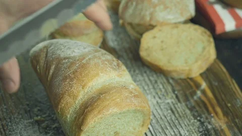 Cut slice of bread in slow motion, close up Stock Footage 72790307
