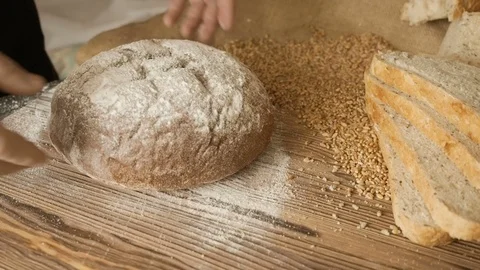 Cut slice of bread on the wooden table, in slow motion, close up Stock Footage 72901190