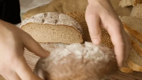 Cut slice of bread on the wooden table, in slow motion, close up Stock Footage 72901454