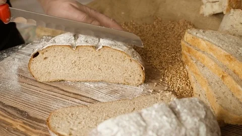 Cut slice of bread on the wooden table, in slow motion, close up Stock Footage 72901695
