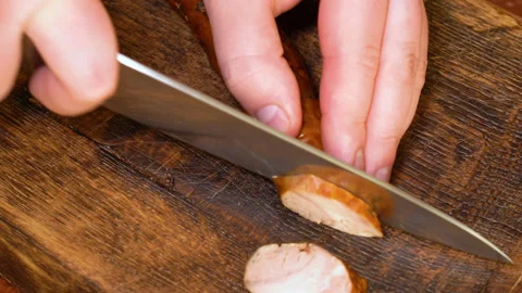 Cut slice of fresh homemade raw sausages on a wooden board Stock Footage 248058229