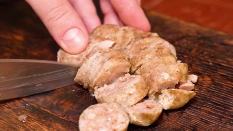 Cut slice of fresh homemade raw sausages on a wooden board Stock Footage 248360322