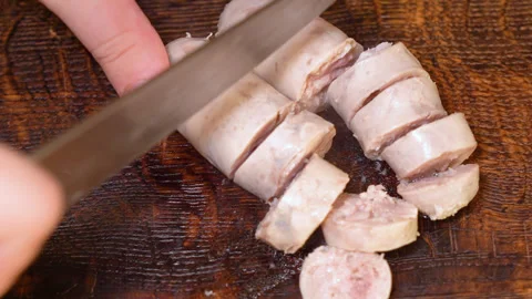 Cut slice of fresh homemade raw sausages on a wooden board Видео 255398693