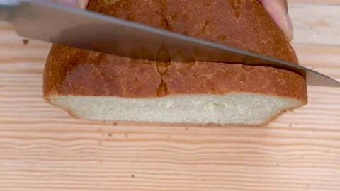 Cut a slice of white bread with a knife on a wooden board. View from above 스톡 동영상 139683275