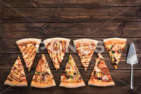 Cut into slices delicious fresh pizza with ham, olives, mushrooms, cheese and Stock Photos