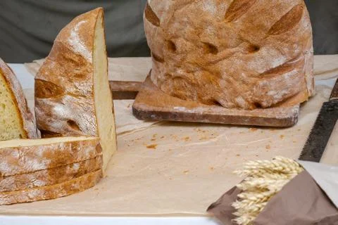 Cut slices of traditional rustic bread on cutting board Stock Photos