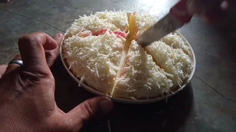 Cut the sponge cake sprinkled with grated cheese Stock Footage 232556394