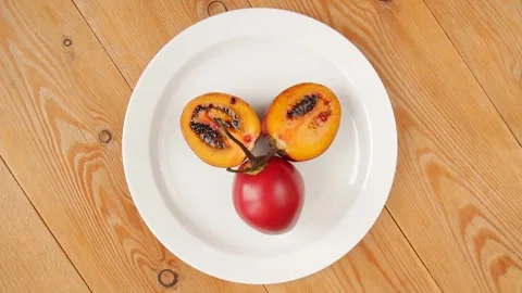 Cut tamarilla on a plate. Stock Footage 243837442