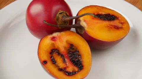 Cut tamarilla on a plate. Stock Footage 244380151