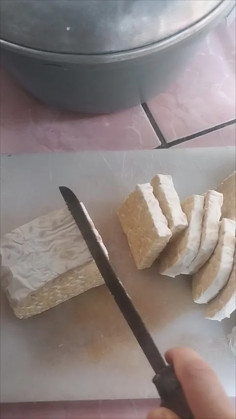 Cut the tempeh into small squares Stock Footage 291763315
