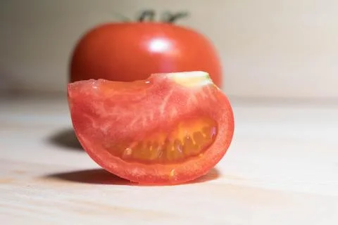 Cut tomato against the background of a whole tomato Stock Photos
