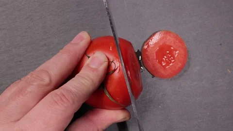 Cut a tomato into slices - top down view Stock-Footage 151058833