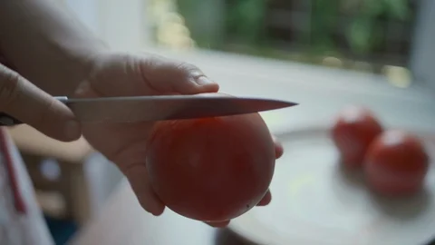 Cut the tomatoes crosswise. Handmade Tomato source recipe Stock Footage 113828207
