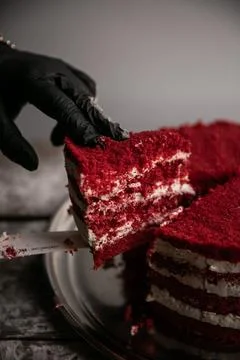 A cut triangular piece of red velvet cake Stock Photos