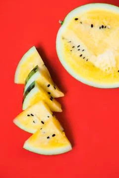 Cut off triangular slices of ripe yellow watermelon on white background 库存照片