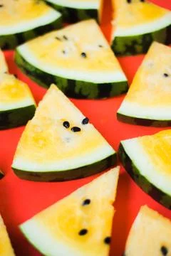 Cut off triangular slices of ripe yellow watermelon on white background 写真素材