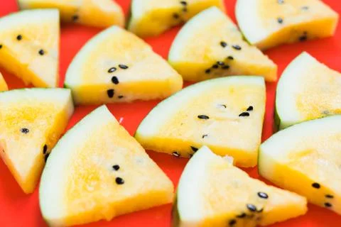 Cut off triangular slices of ripe yellow watermelon on white background 스톡 사진