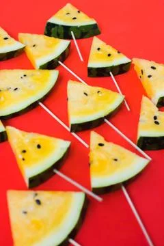 Cut off triangular slices of ripe yellow watermelon on white background 스톡 사진