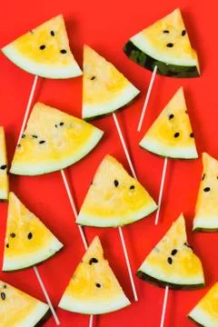 Cut off triangular slices of ripe yellow watermelon on white background 스톡 사진