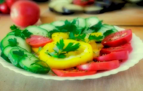 Cut vegetables on a plate on the table. Stock Photos