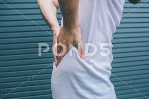 Cut view of man holding hands on back. It hurts. Guy is suffering. Isolated o Stock Photos