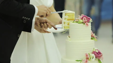 Cut the wedding cake. The bride and groom cut the wedding cake. Detail of Video stock 196003808