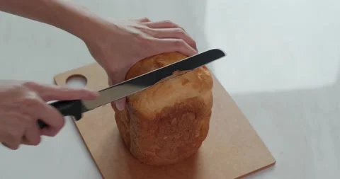 Cut a white bread with knife Stock Footage 132298656