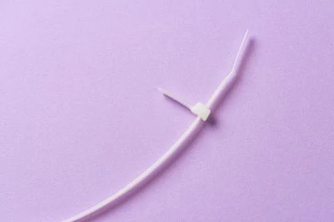 Cut up white plastic cable tie Stock Photos