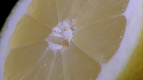 Cut Yellow Lemon - Macro Close up View on a Black Background Stock Footage 90220103