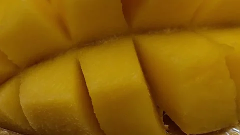 Cut yellow mango into slices, fruit composition, macro photography Video stock 325125945