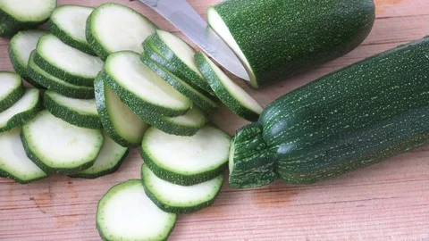 Cut zucchini on chopping board for cooking Stock Footage 80340737