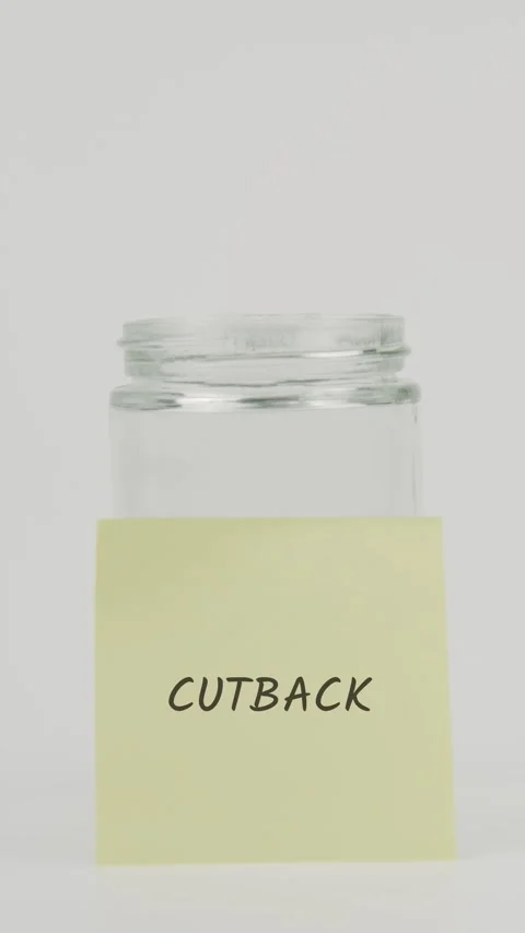 Cutback text or word on yellow sticky note attached to glass jar with hand Stock Footage 311707073