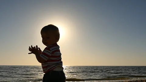 Cute 1 + old baby making applaud  motions silhouette Stock Footage 89699159