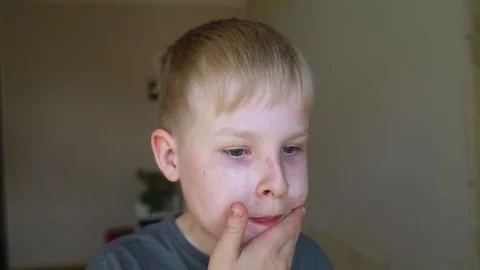 Cute 10 years old boy applying mineral sunscreen stick on his face. Caucasian ch Stock Footage 338396551